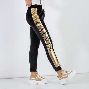 Black women's insulated sweatpants with gold piping - Odież